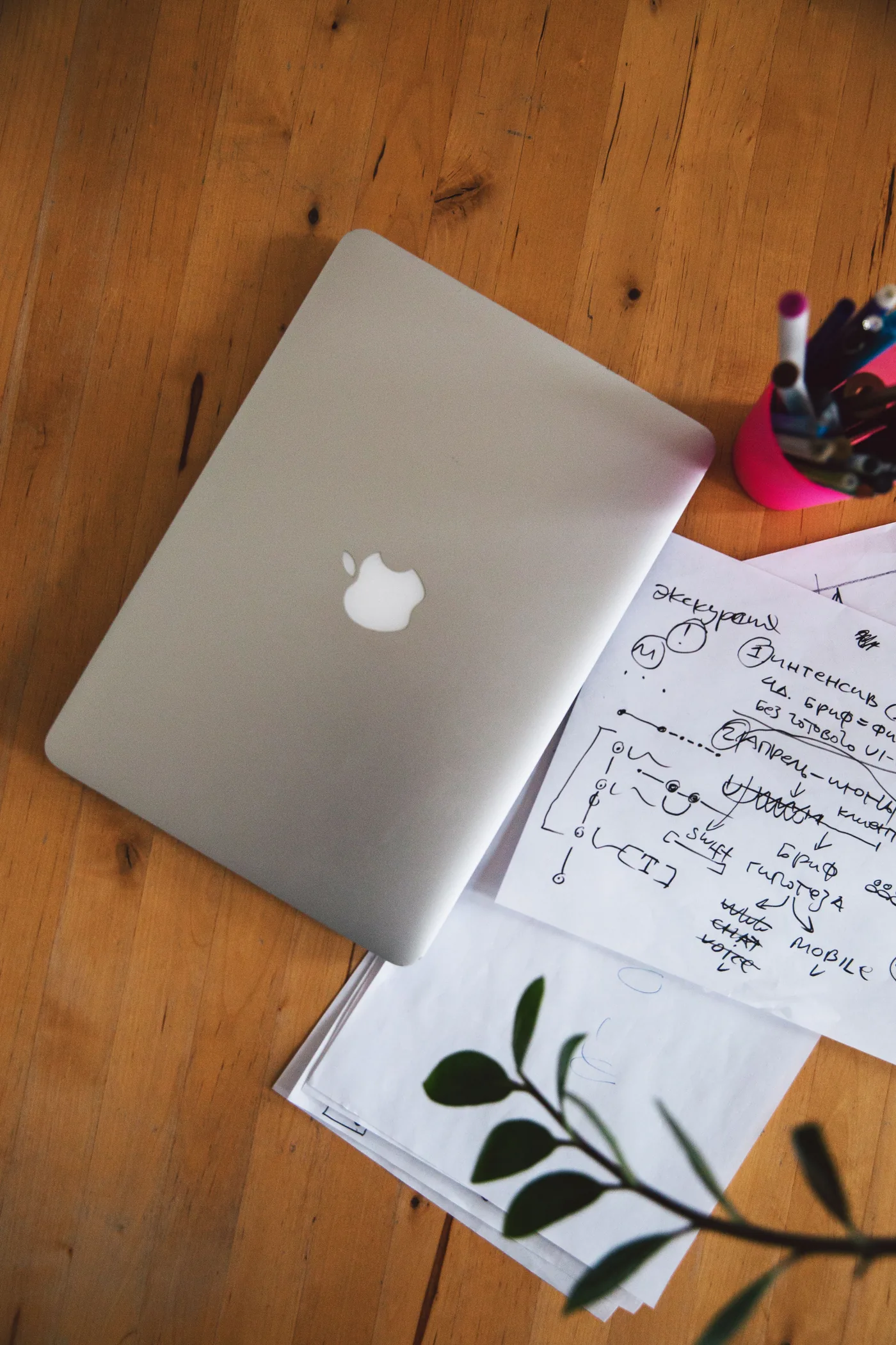 Laptop and planning notes on a wooden desk